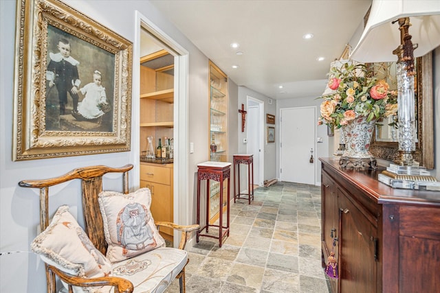 hallway with recessed lighting and stone finish flooring