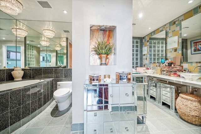 bathroom with tile patterned flooring, vanity, tile walls, and toilet