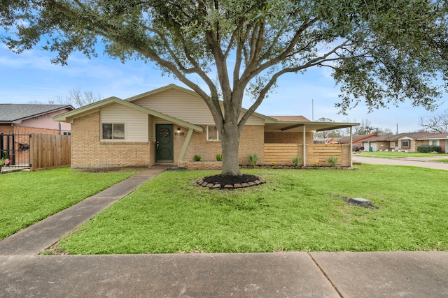 ranch-style house with a carport and a front lawn