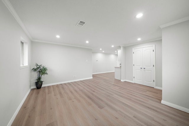 basement featuring ornamental molding and light hardwood / wood-style flooring