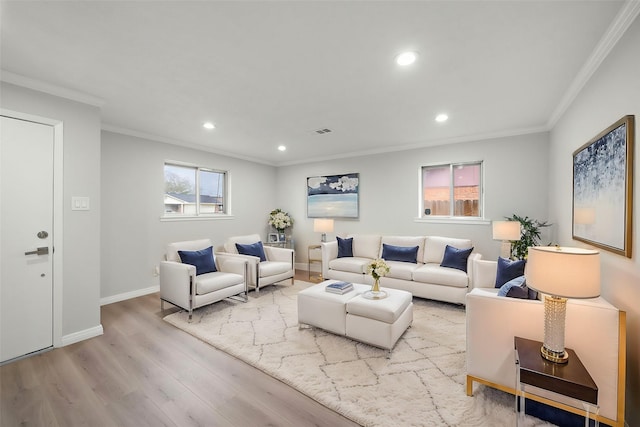 living room with ornamental molding and light hardwood / wood-style flooring