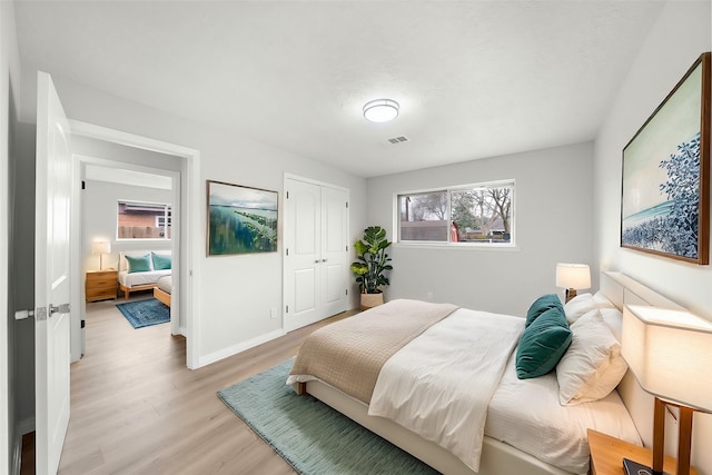 bedroom featuring a closet and light wood-type flooring