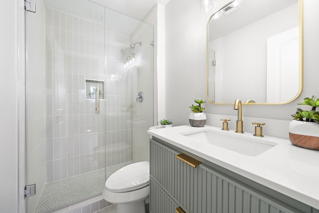 bathroom with vanity, toilet, and an enclosed shower