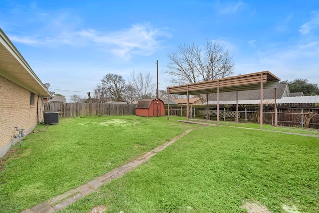 view of yard with central AC and a shed