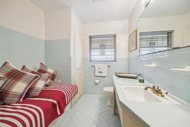 bathroom featuring vanity, tile walls, tile patterned floors, and toilet