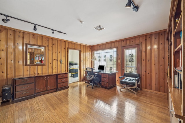 office with track lighting and light hardwood / wood-style floors