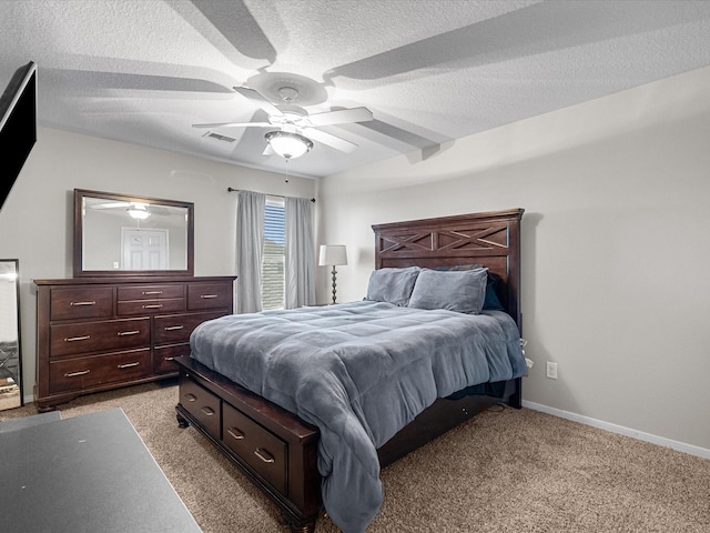 bedroom with ceiling fan, light carpet, and a textured ceiling