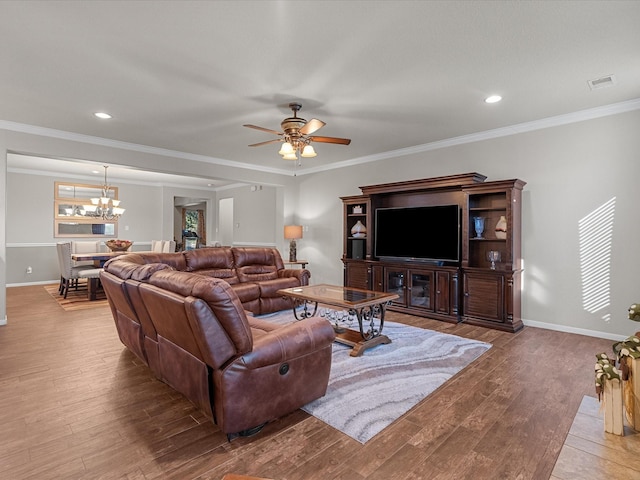 living room with crown molding, ceiling fan with notable chandelier, and light hardwood / wood-style flooring