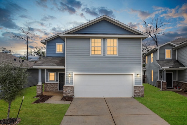 view of front facade with a garage and a lawn