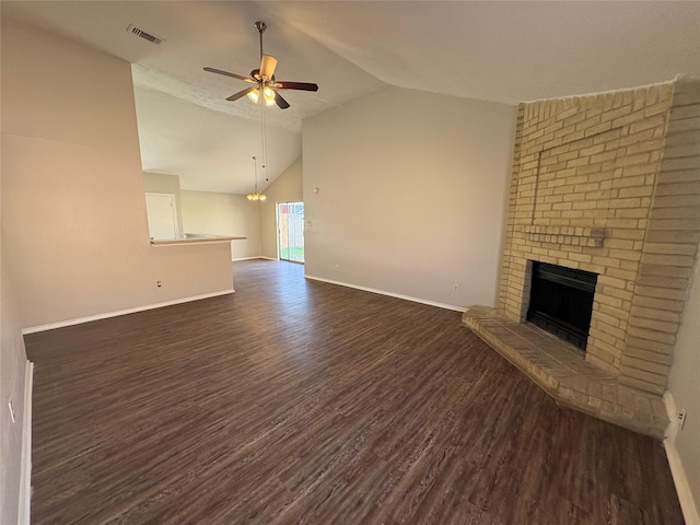 unfurnished living room featuring a brick fireplace, dark hardwood / wood-style floors, ceiling fan with notable chandelier, and high vaulted ceiling