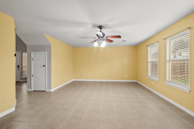 tiled spare room featuring lofted ceiling and ceiling fan