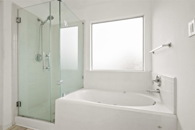 bathroom featuring separate shower and tub