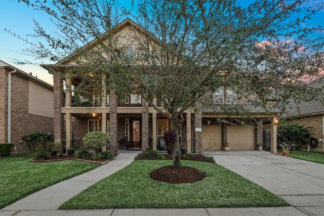 view of front of home with a yard and a balcony