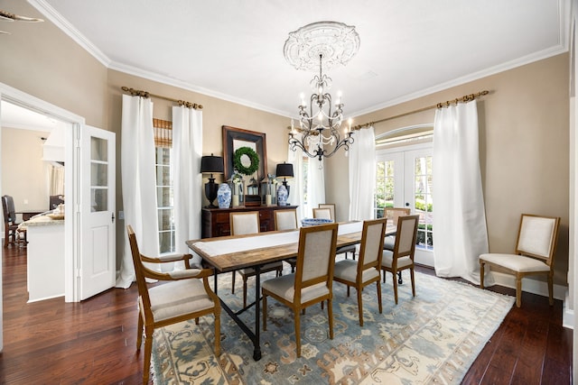 dining space with french doors, crown molding, a chandelier, and dark wood-type flooring