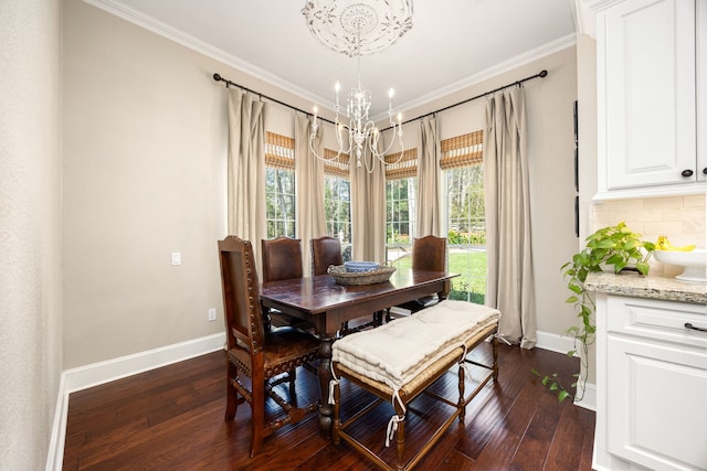 dining room featuring dark wood-type flooring, ornamental molding, and a chandelier