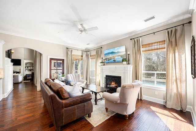 living room featuring crown molding, dark hardwood / wood-style floors, and ceiling fan