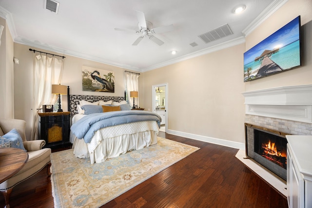 bedroom with crown molding, dark wood-type flooring, and ceiling fan