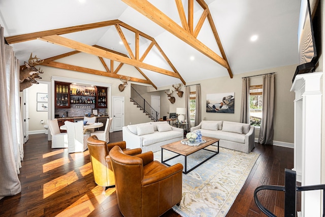 living room featuring high vaulted ceiling, dark hardwood / wood-style floors, beamed ceiling, and ornate columns