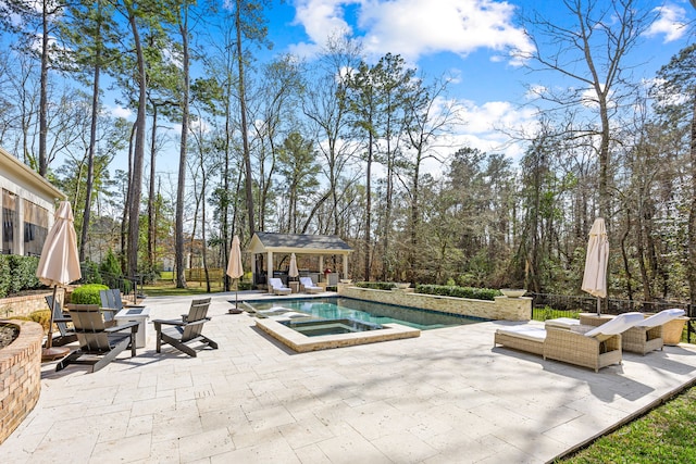 view of swimming pool featuring an in ground hot tub, an outdoor structure, and a patio