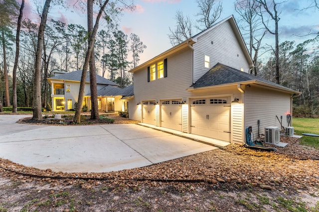 exterior space featuring a garage and ac unit