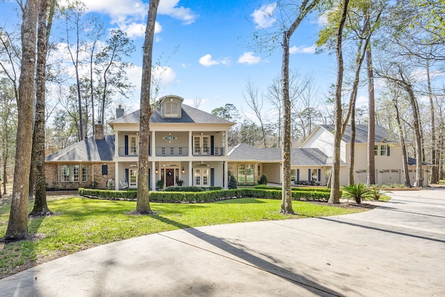 view of front of house with a garage, french doors, and a front lawn