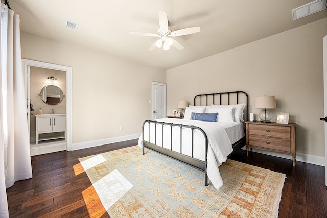 bedroom with ensuite bathroom, dark hardwood / wood-style floors, and ceiling fan