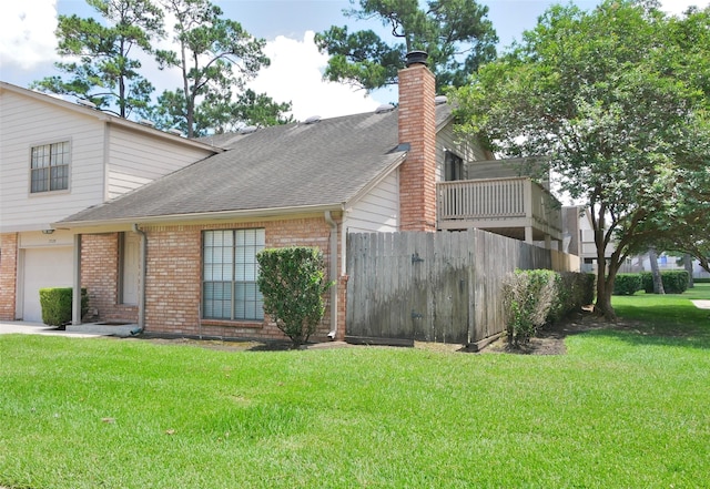 view of property exterior with a garage, a balcony, and a yard