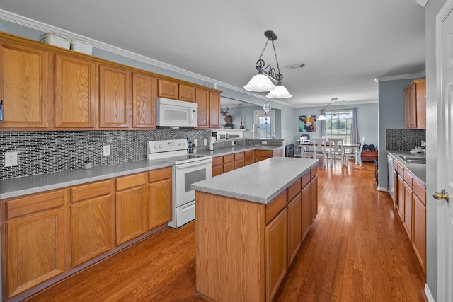 kitchen featuring pendant lighting, white appliances, light hardwood / wood-style floors, and a kitchen island