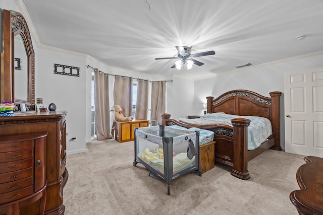 carpeted bedroom featuring ceiling fan and ornamental molding