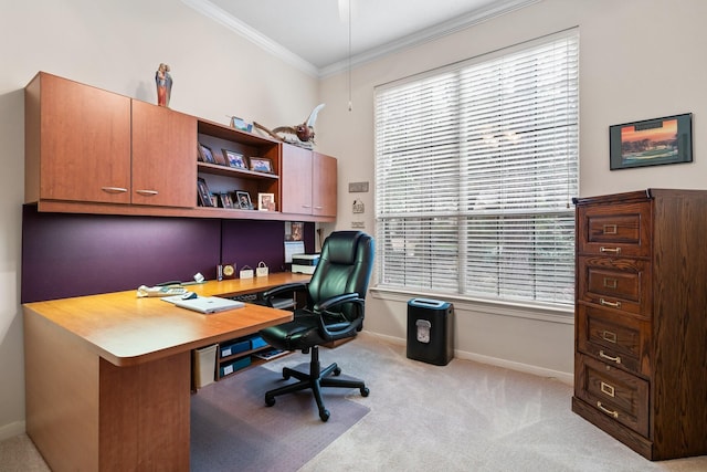 home office featuring light carpet, ornamental molding, and a healthy amount of sunlight