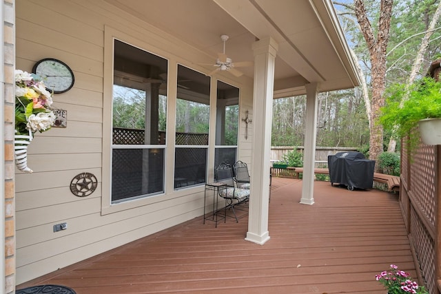 wooden terrace featuring ceiling fan and area for grilling