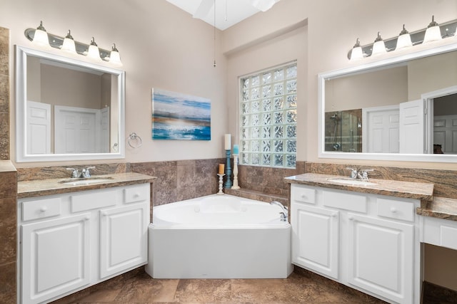 bathroom with vanity, shower with separate bathtub, tile walls, and ceiling fan