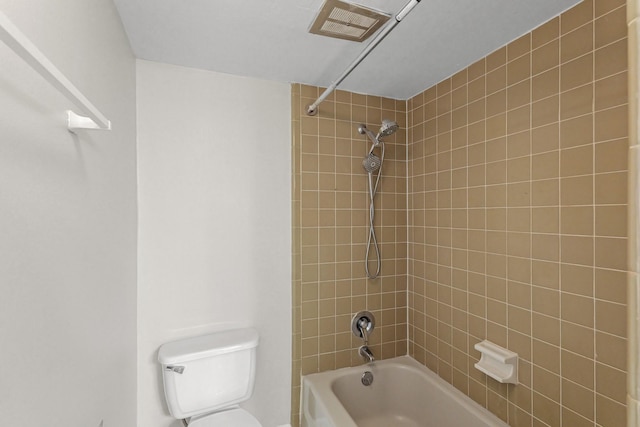 bathroom with tiled shower / bath and toilet