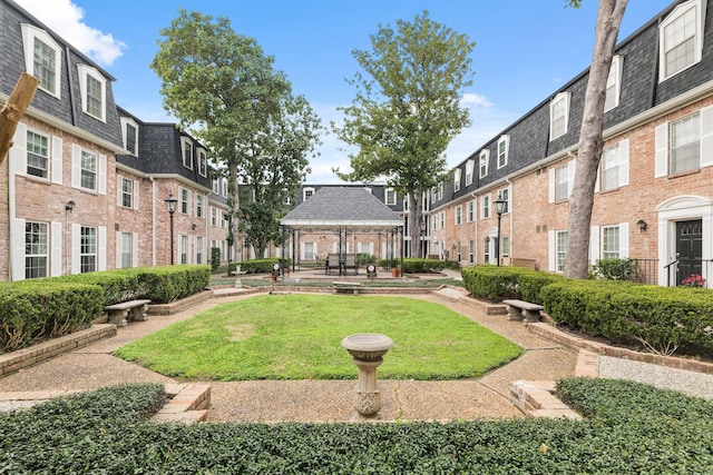 view of property's community featuring a gazebo and a lawn