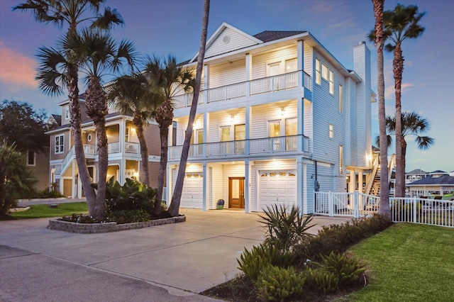 view of front of property featuring a balcony and a garage