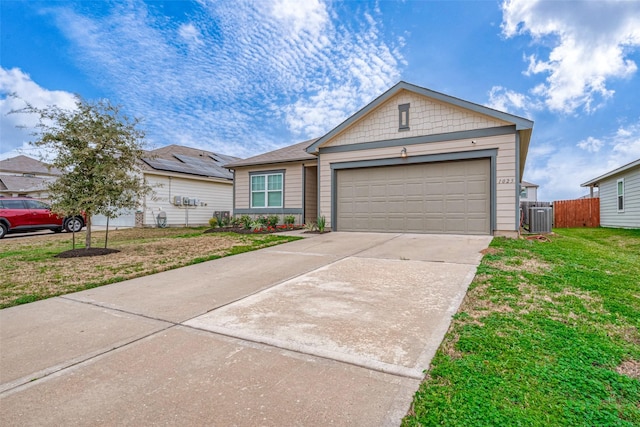 view of front of property featuring a garage, central AC unit, and a front yard