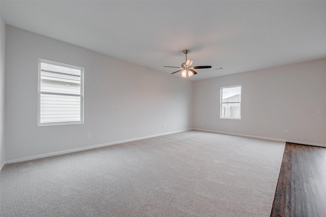 carpeted empty room featuring ceiling fan