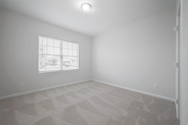 unfurnished room featuring light colored carpet