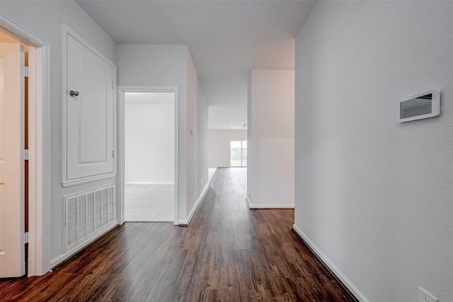 corridor featuring dark wood-type flooring