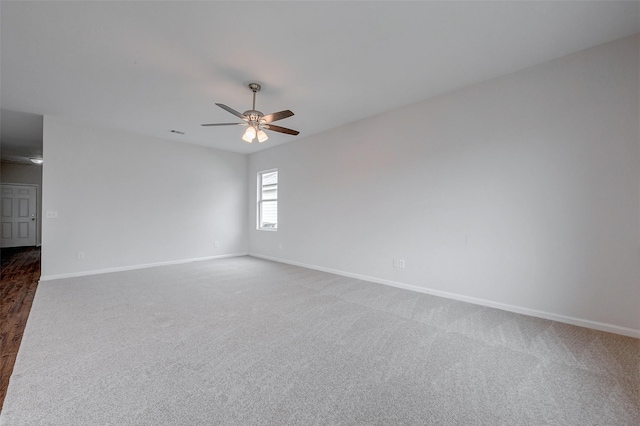 carpeted spare room featuring ceiling fan