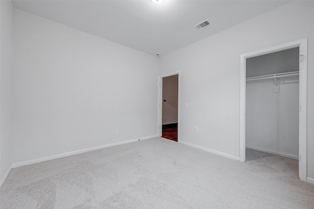 unfurnished bedroom with carpet and a closet