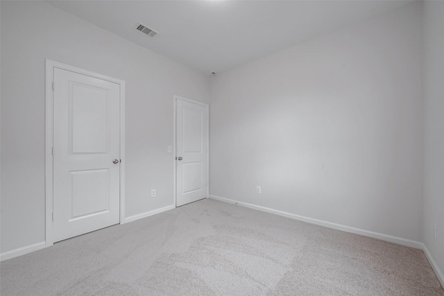 unfurnished bedroom featuring light carpet