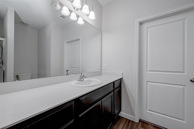 bathroom with vanity, hardwood / wood-style floors, and toilet