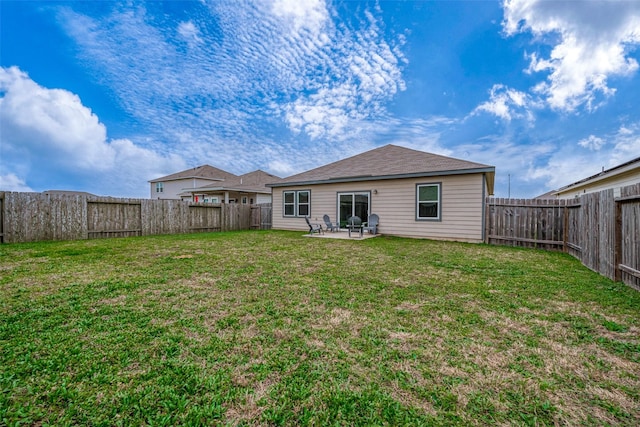 rear view of property featuring a yard and a patio area