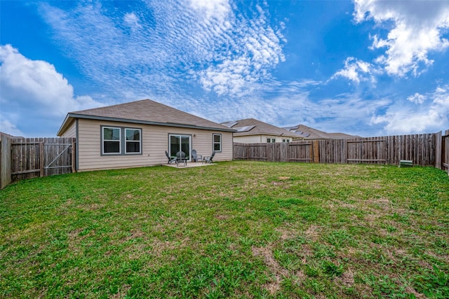 back of property with a patio area and a lawn