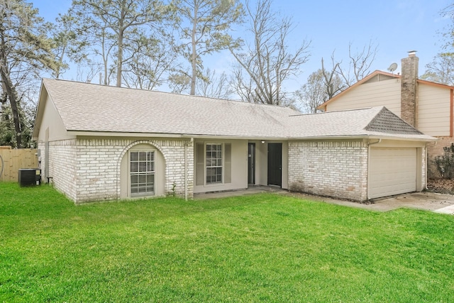 view of front of home with central air condition unit, brick siding, roof with shingles, and a front lawn