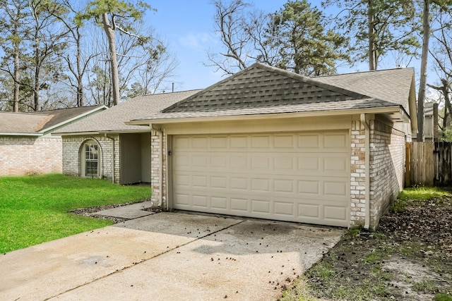 view of front facade featuring brick siding, a front lawn, an attached garage, and a shingled roof