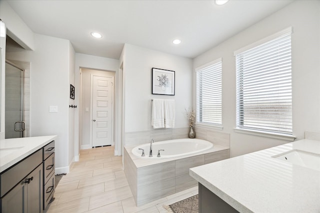 bathroom featuring vanity and shower with separate bathtub