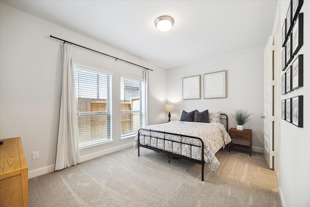 bedroom featuring light colored carpet