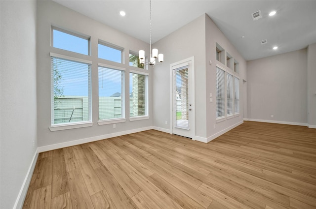 interior space featuring an inviting chandelier and light wood-type flooring